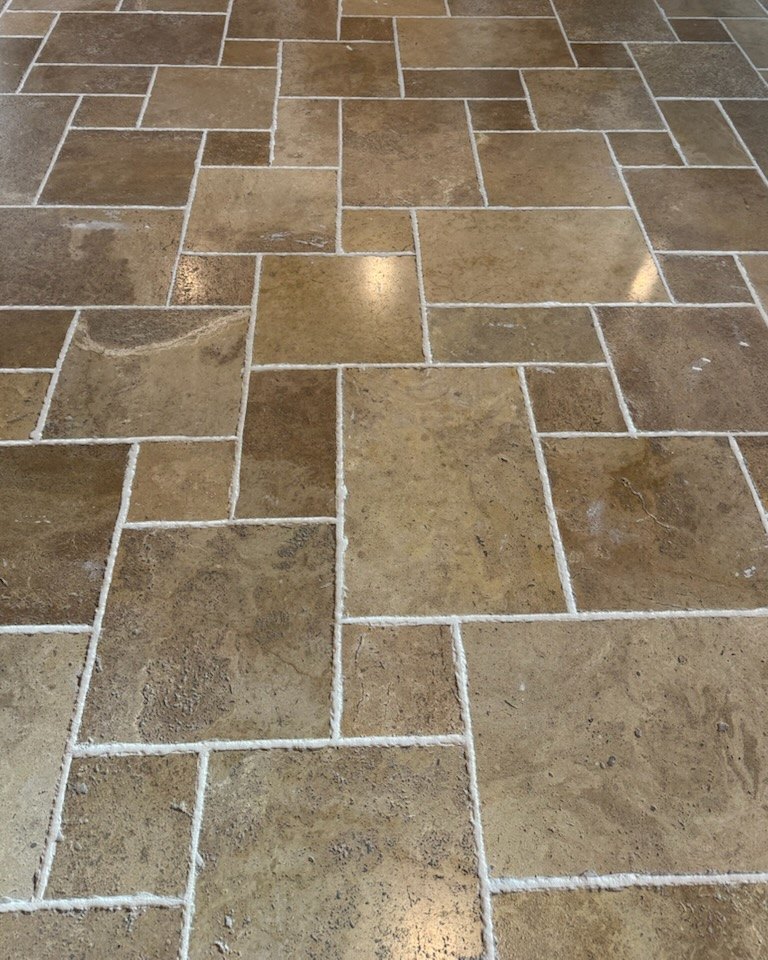 The same travertine floor after professional cleaning and sealing by Empire Grout